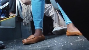 Ebony Woman in brown flats on the bus