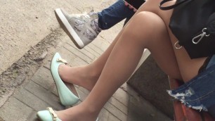 A beautiful girl with blue flats and pantyhose is shoeplaying