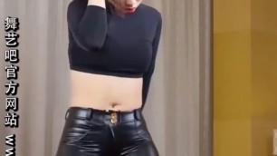 Sexy Chinese dancer in tight, shiny leather look leggings