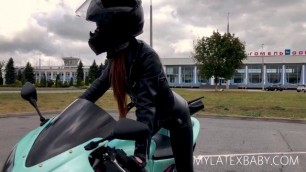 SEXY RED-HAIRED MOTOGIRL IN LEATHER LEGGINGS